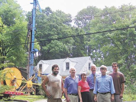 Drilling a geothermal well in front of a customers house