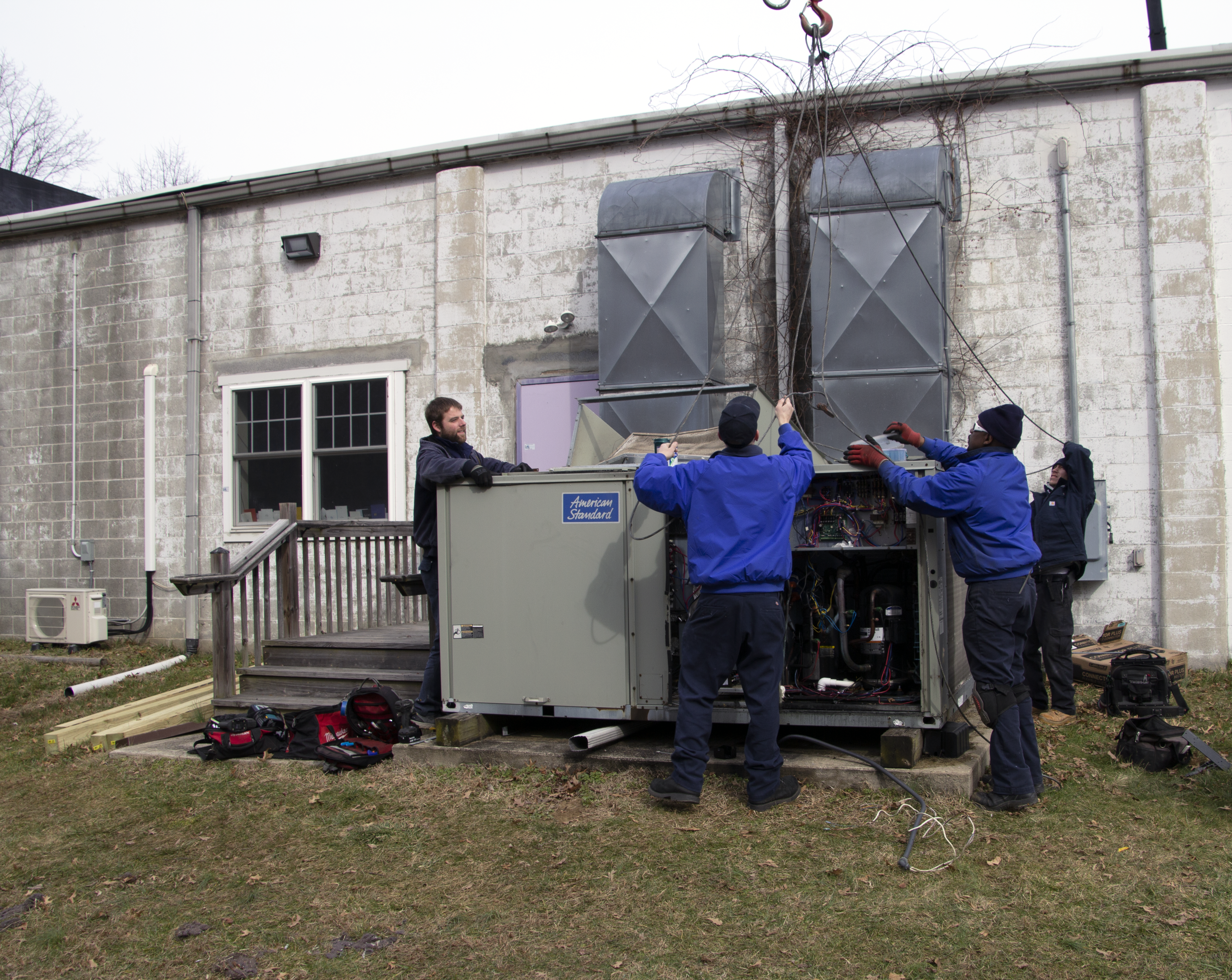Team of Technicians Installing Commercial HVAC Unit