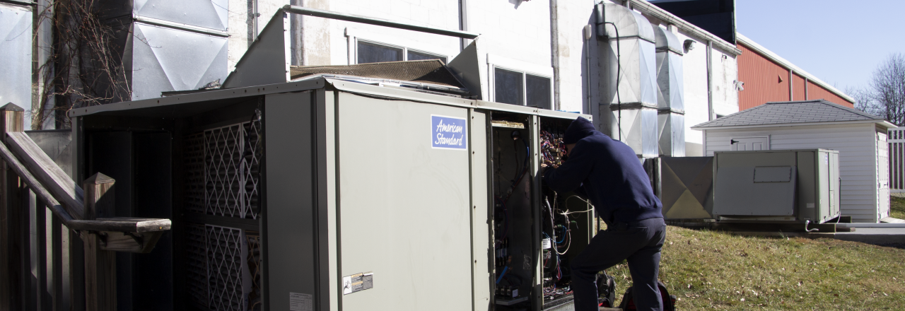 Team of Technicians Installing Commercial HVAC Unit with Crane