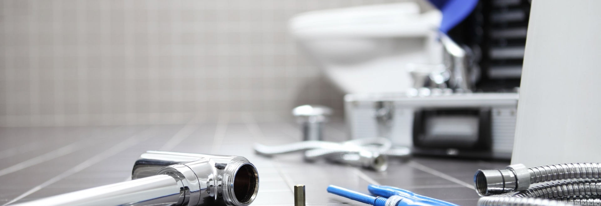 Tools littering the floor of a residential bathroom