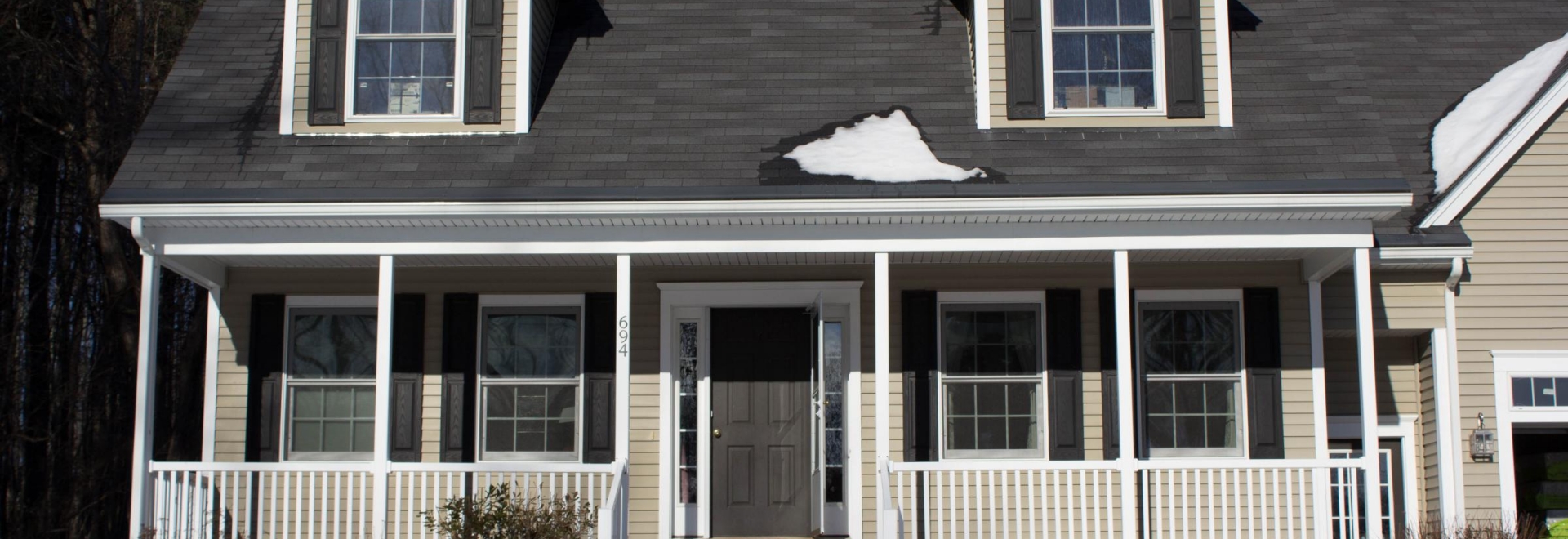 Front of house with porch, and a noticeable lack of ice dams!