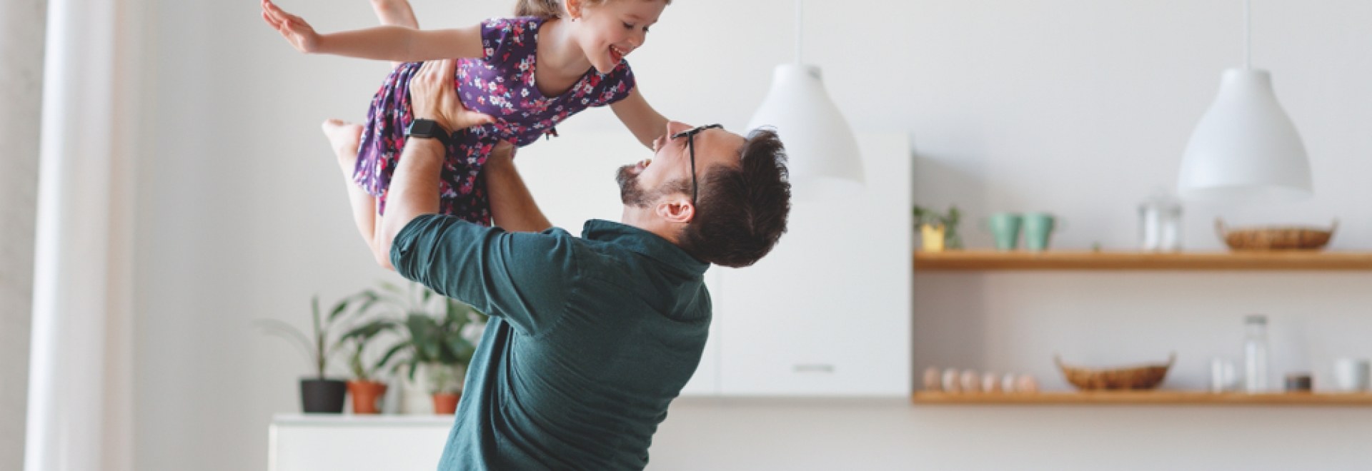 Father Lifting Daughter in Air