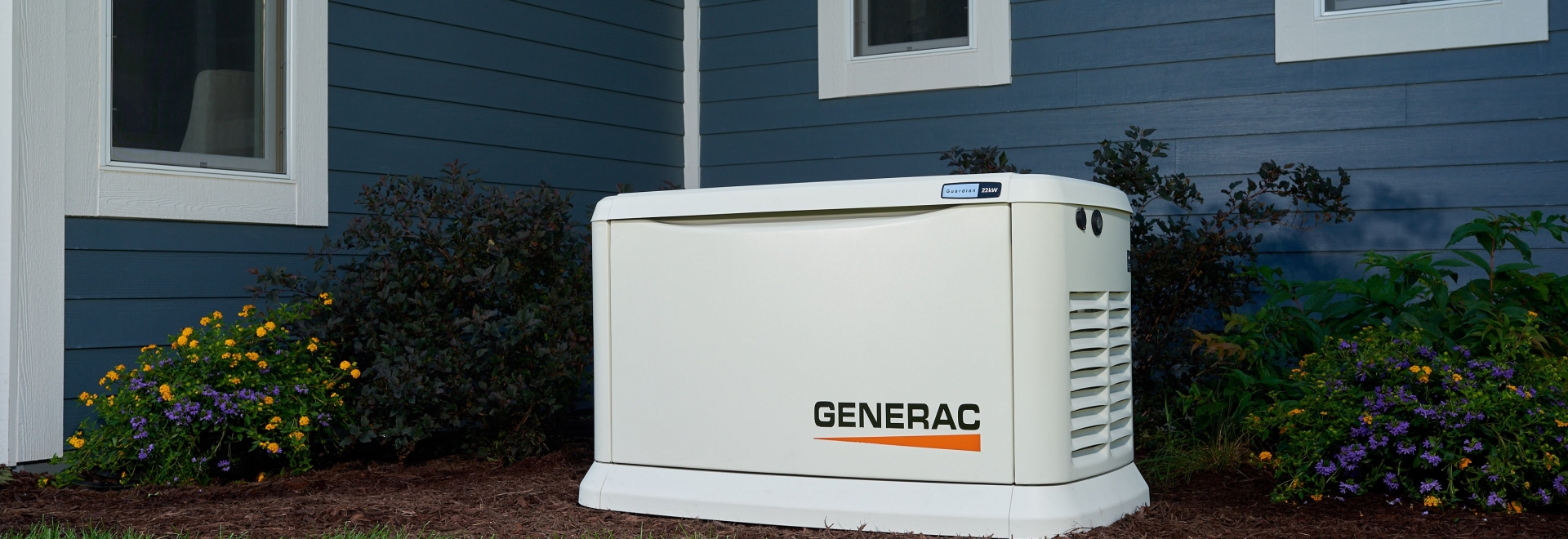 Generac Generator Outside of Beautiful Blue Home