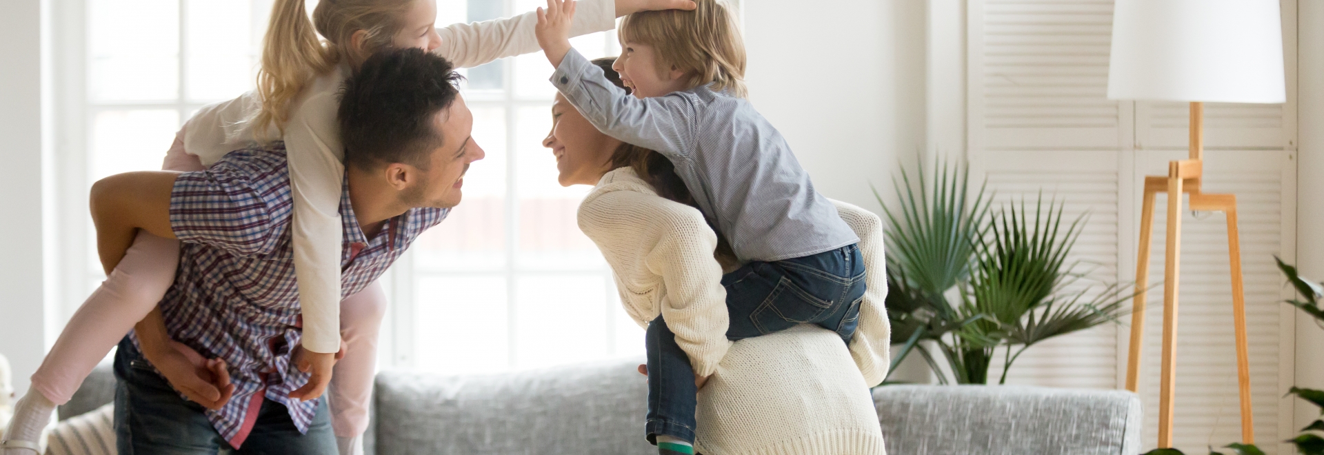 Couple Giving Children Piggyback Rides