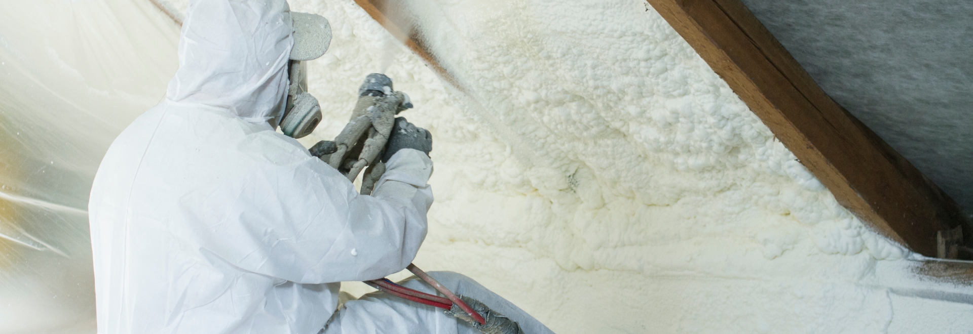 Technician Applying Spray Foam Insulation to Attic