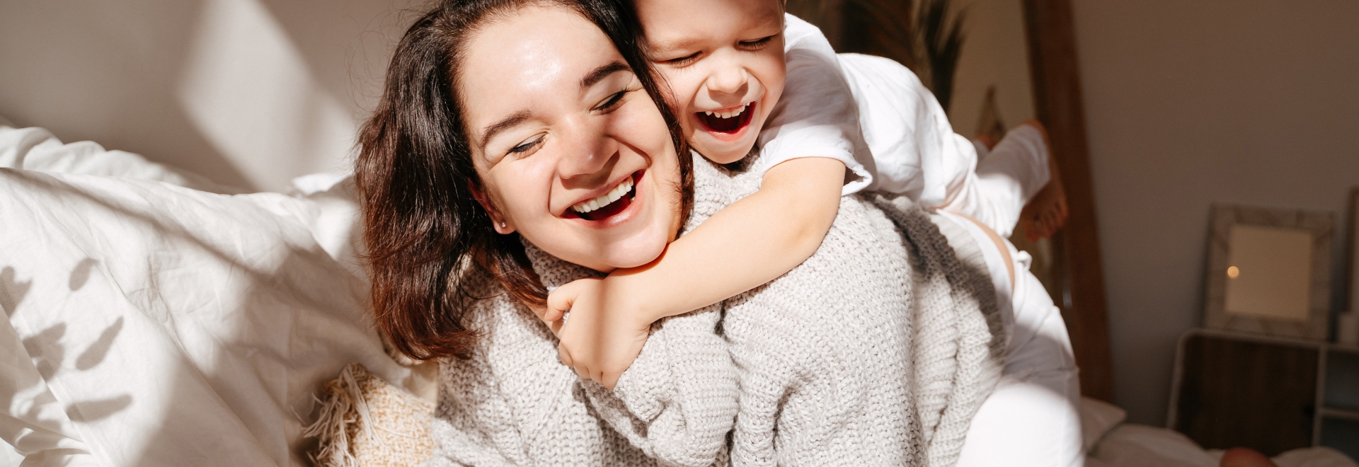 Happy Mother Playing With Baby Boy 