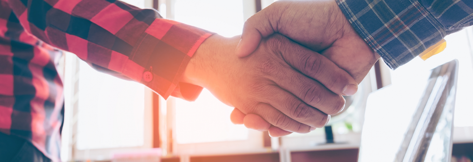 Shaking Hands In Front of Work Desk 