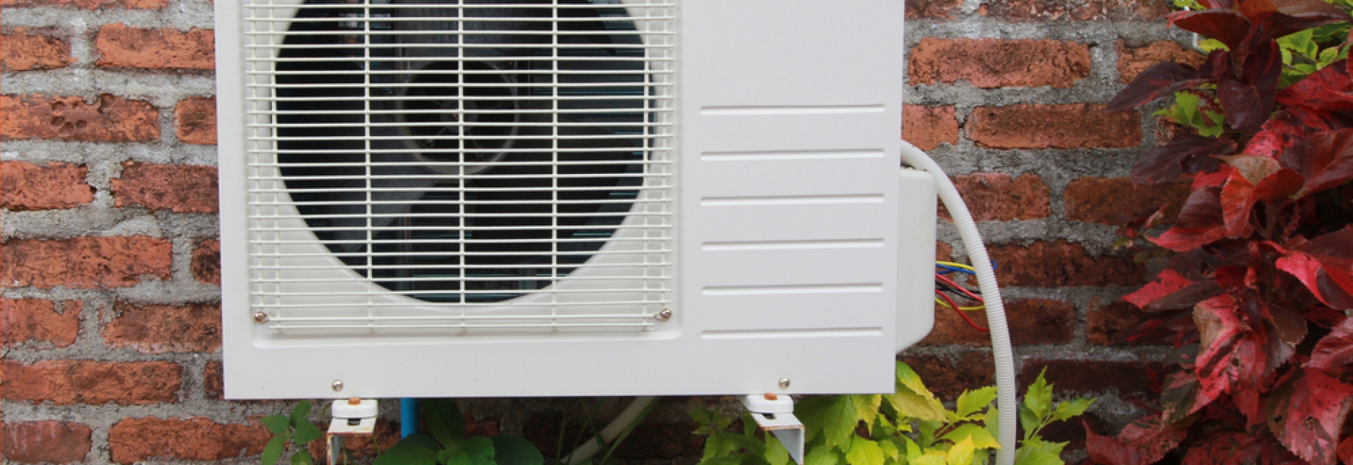 heat pump unit outside window of brick home