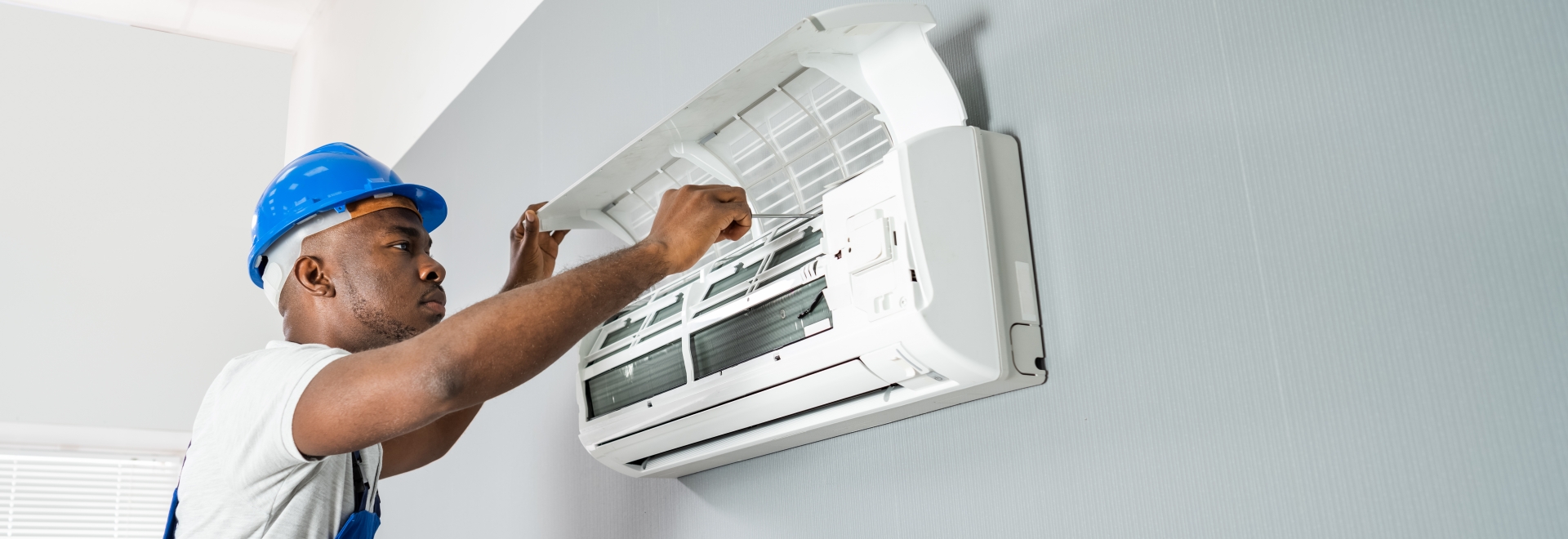 Man providing maintenance to a HVAC system