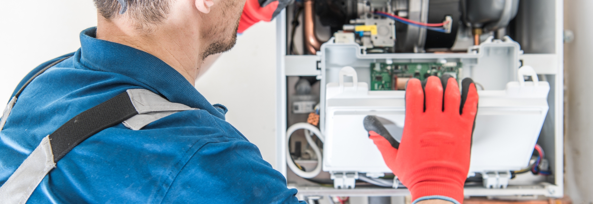 man repairing a furnace