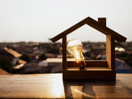 home electrification concept, light bulb with house model