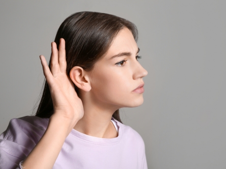 woman at home listening closely