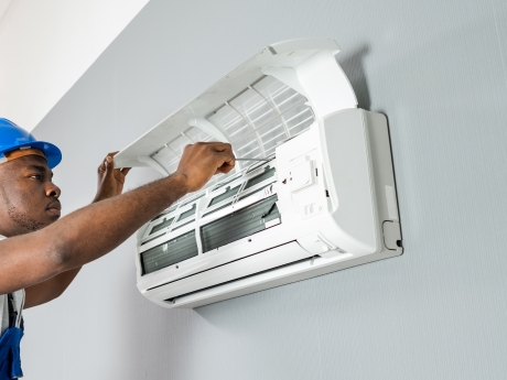 Man providing maintenance to a HVAC system