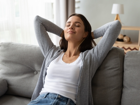 Woman breathing in clean air in her home