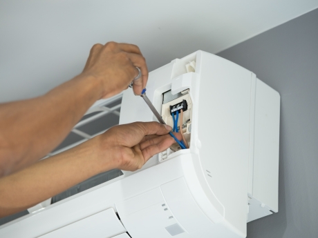 Man fixing a heat pump