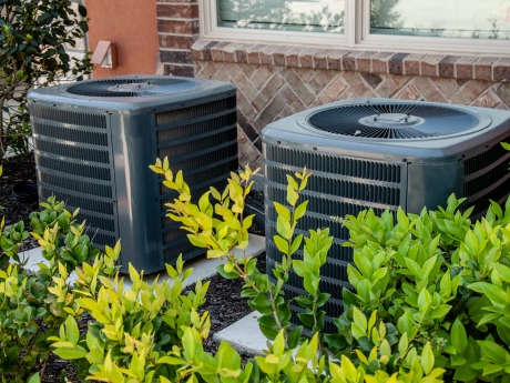 hvac units outside near a bush