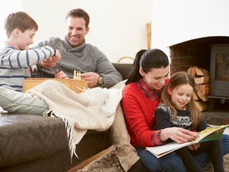 family spending time together during the winter by the fire place