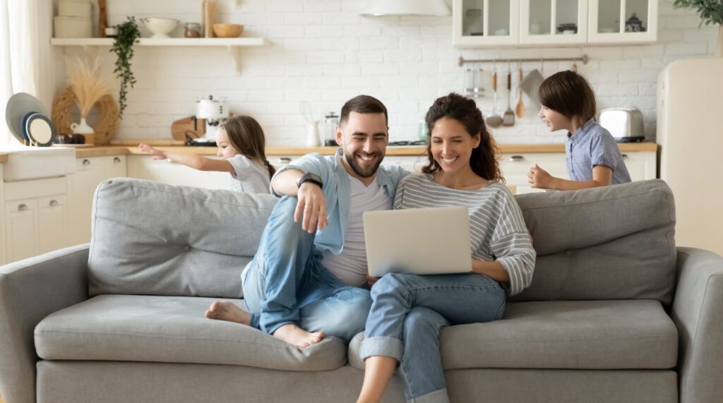A couple looks up 2025 heating rebates on their laptop