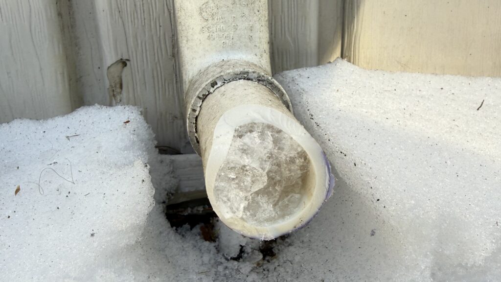A frozen exterior PVC pipe is shown. Princeton Air techs can provide tips for preventing frozen pipes during extreme cold in New Jersey