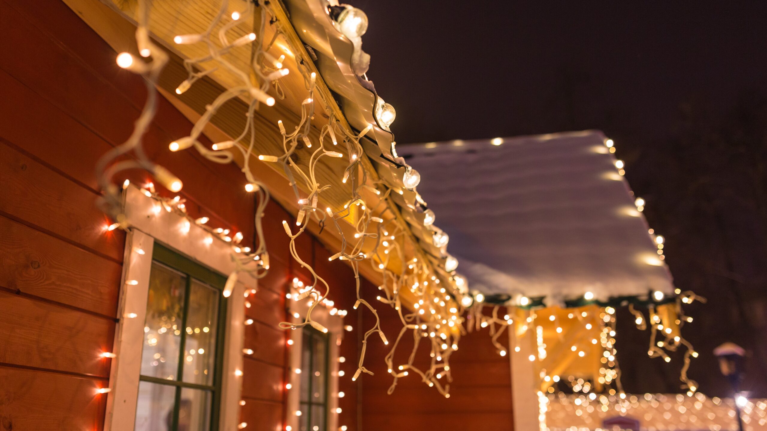 Exterior holiday lights on a home are shown. Princeton Air provides electrical safety tips for holiday power usage.